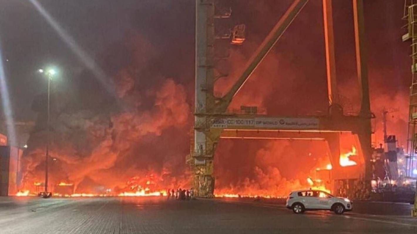 A container ship anchored at Dubai's huge port has caught fire, causing an explosion that sent tremors across the commercial hub of the United Arab Emirates.